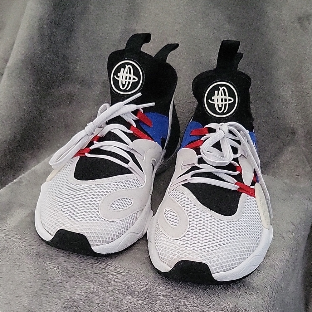 Stylish Light Grey and Black Sneakers with Blue and Red Accents.